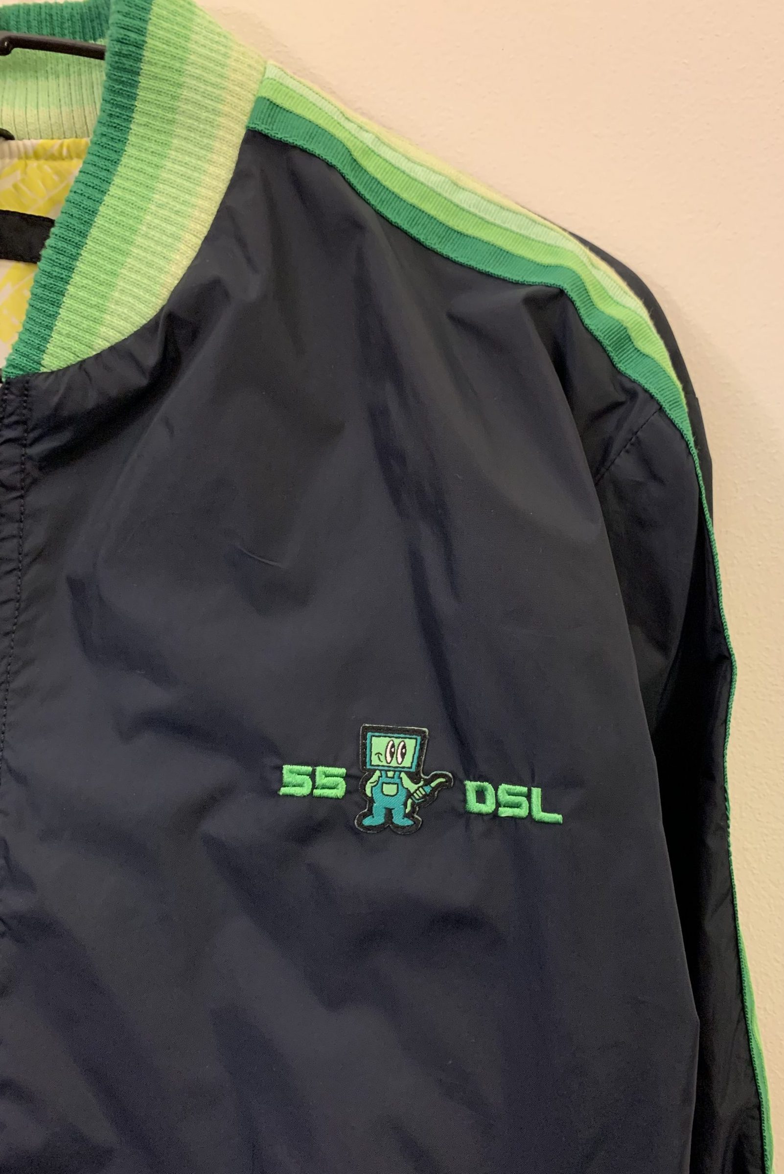 A jacket displaying the 55DSL Logo and Forecourt Attendant Fuel Pump Character Icon